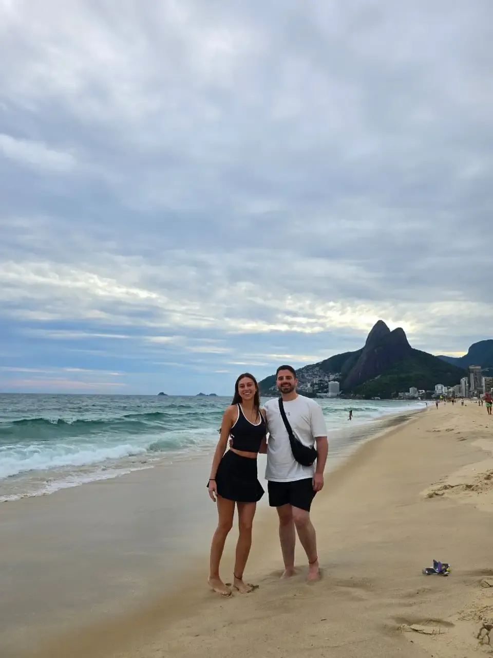 couple on ipanema beach with two brothers mountain